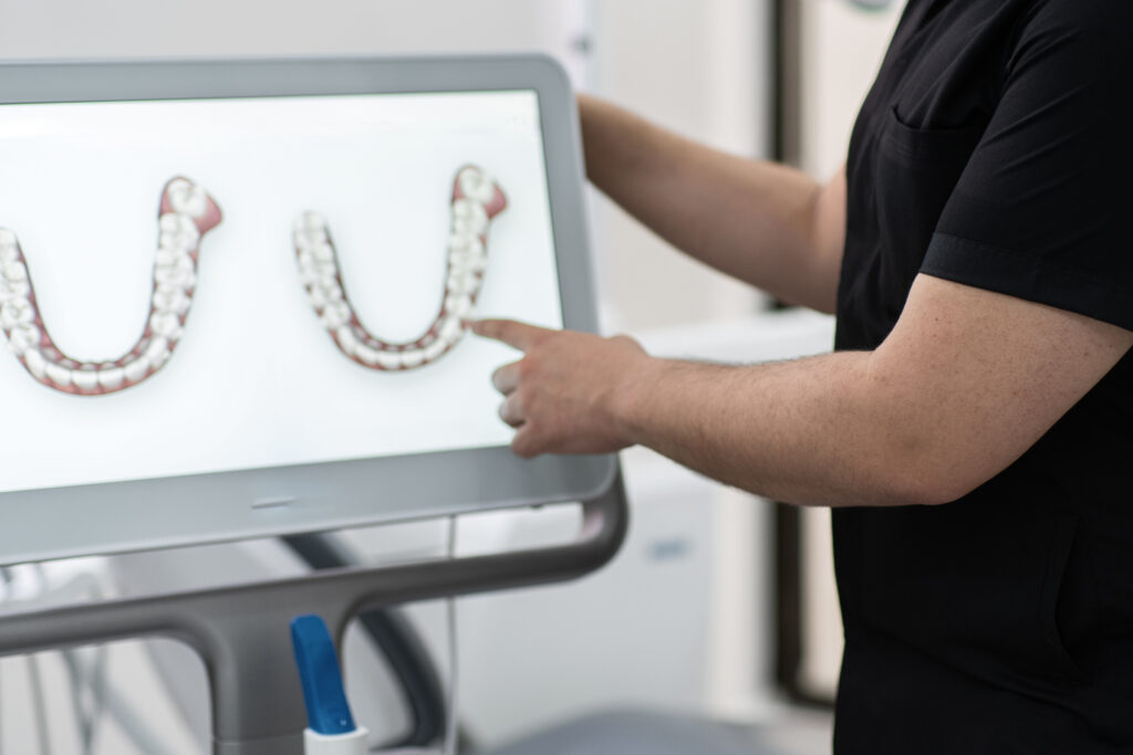 DentiQue Stomatologia Wrocław dentist showing human jaws models on digital scree 2024 11 25 12 35 48 utc